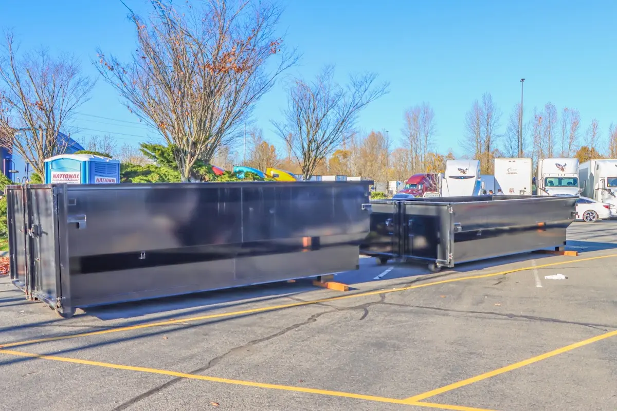 Professional dumpster rental service with roll-off container on residential driveway in Longwood